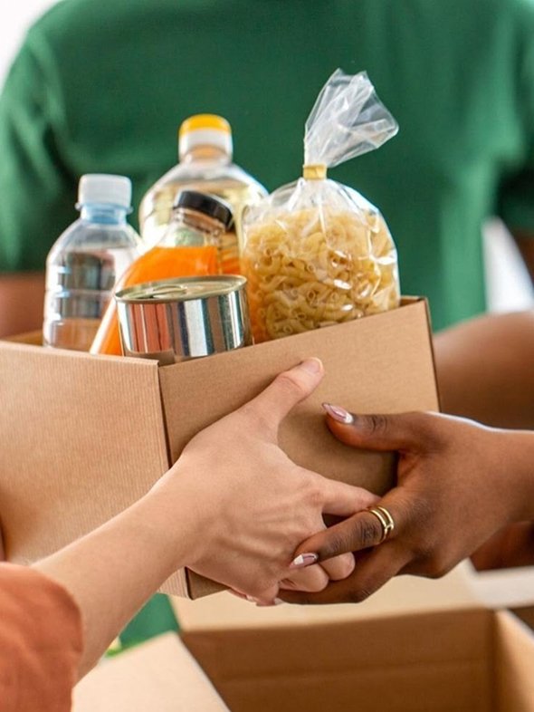 Box of groceries being handed over