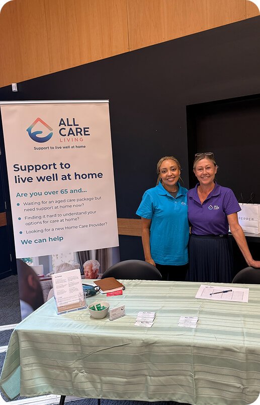 All Care Living team members standing beside a "Support to live well at home" banner