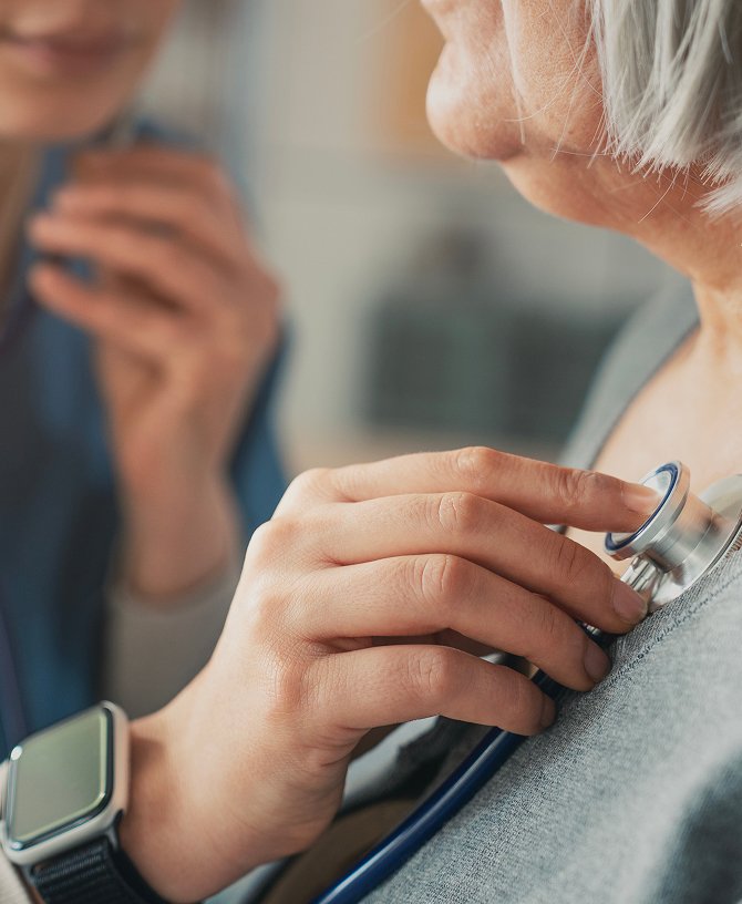 Nurse taking an older person’s blood pressure