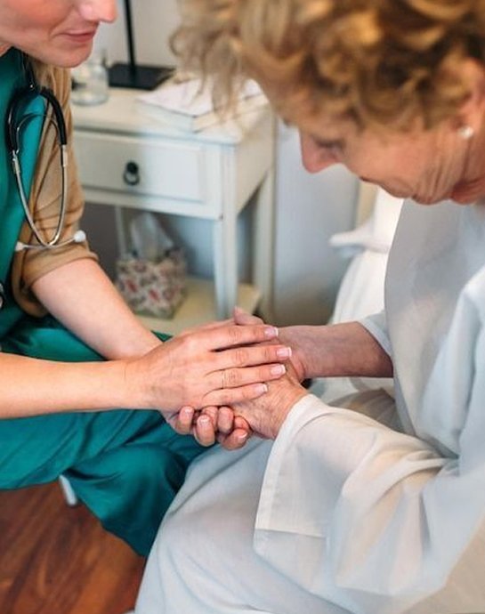 Carer holding an older person’s hands